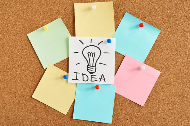 istock painted light bulb lamp with word idea and colored blank notes on a cork board 1140917035
