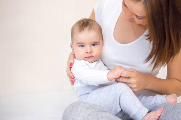 istock young mother is playing with her happy baby 1140917962