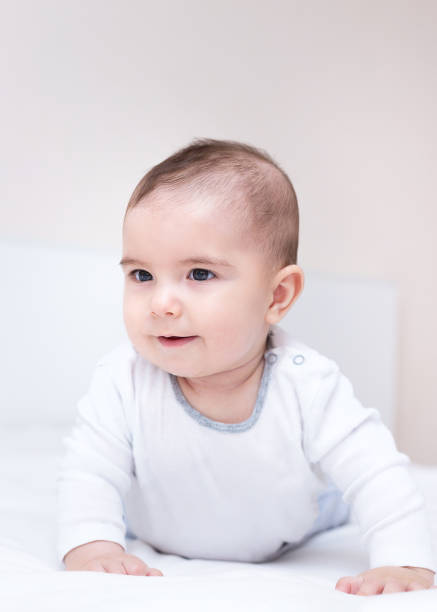 istock Little cute baby is crawling on a white bed 1140918024