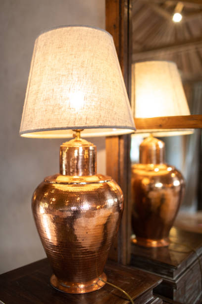 istock Bronze lamp on wood table. 1140918026