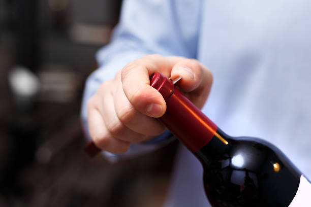istock sommelier is opening a bottle of wine with a corkscrew 1140927637