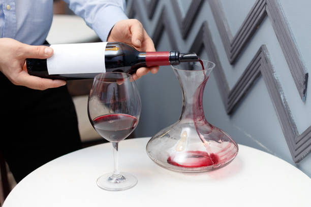 istock sommelier is pouring wine into a decanter 1140927676