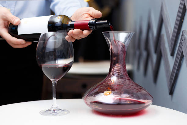 istock sommelier is pouring wine into a decanter 1140927690