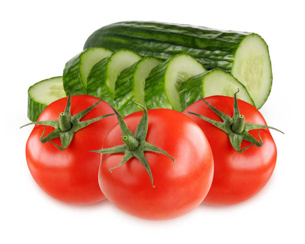 istock red tomatoes and green cucumbers isolated on white background. 1140927884