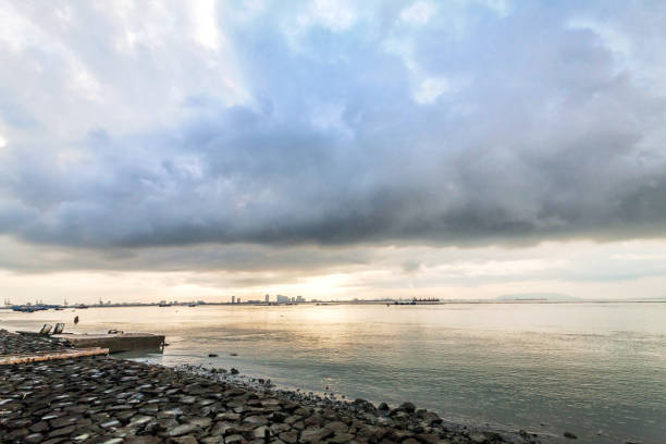 istock Rocky shore view with sunrise or sunset background 1140930583