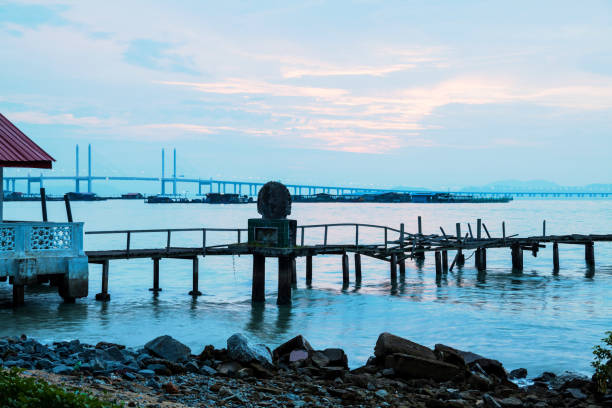 istock Long exposure view of a bridge by shore in black and white 1140931544