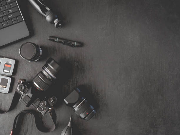 istock top view of work space photographer with digital camera, flash, cleaning kit, memory card, external harddisk, USB card reader, laptop and camera accessory on black table background 1140936734