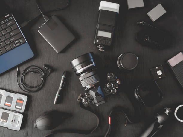 istock top view of work space photographer with digital camera, flash, cleaning kit, memory card, external harddisk, USB card reader, laptop and camera accessory on black table background 1140936793
