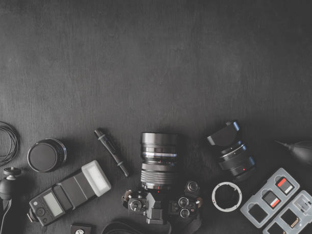 istock top view of work space photographer with digital camera, flash, cleaning kit, memory card, external harddisk, USB card reader, laptop and camera accessory on black table background 1140936799