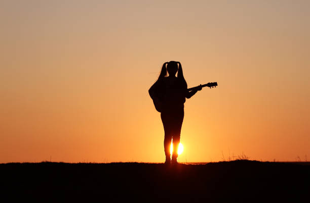 istock Silhouette of a guitar player at sunset 1140936931