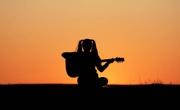 istock Silhouette of a guitar player at sunset 1140936934