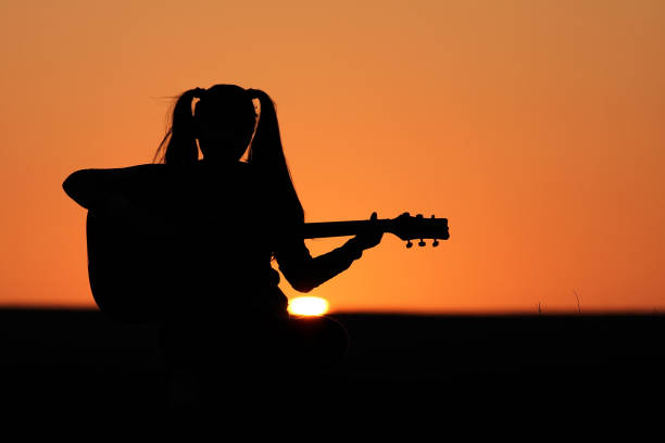 istock Silhouette of a guitar player at sunset 1140937136