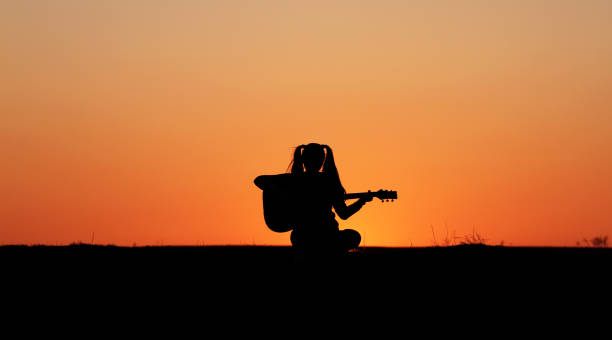 istock Silhouette of a guitar player at sunset 1140937142