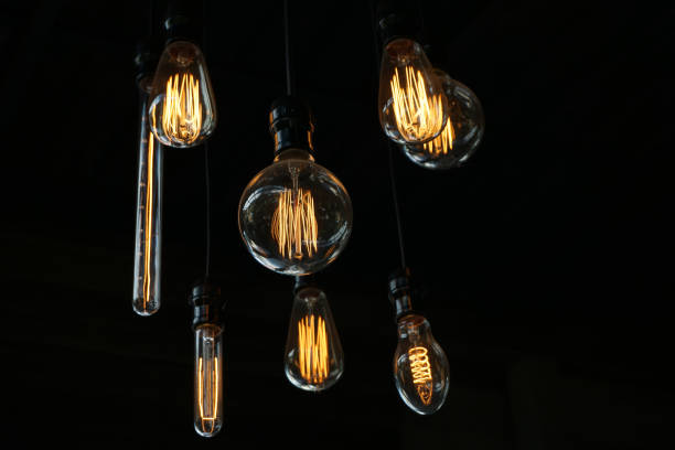 istock Low Angle View Of Illuminated Light Bulbs Against Black Background 1140938269