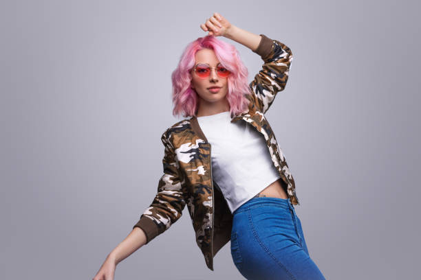 Stylish woman dancing and looking at camera