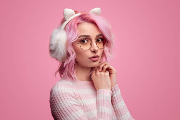 istock Cute woman in earmuffs clasping hands 1140940697