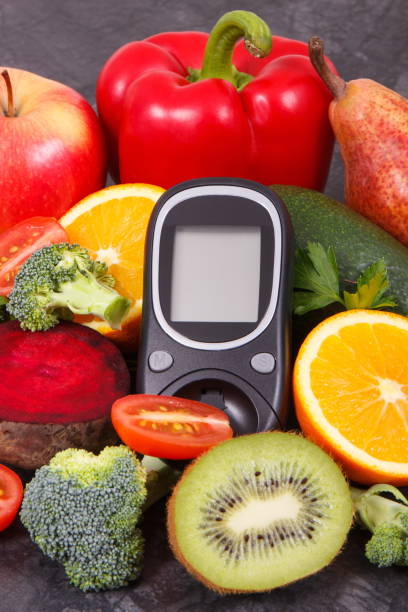 istock Glucometer for measuring sugar level and fruits with vegetables containing minerals and vitamins, diabetes and healthy lifestyles concept 1140941339
