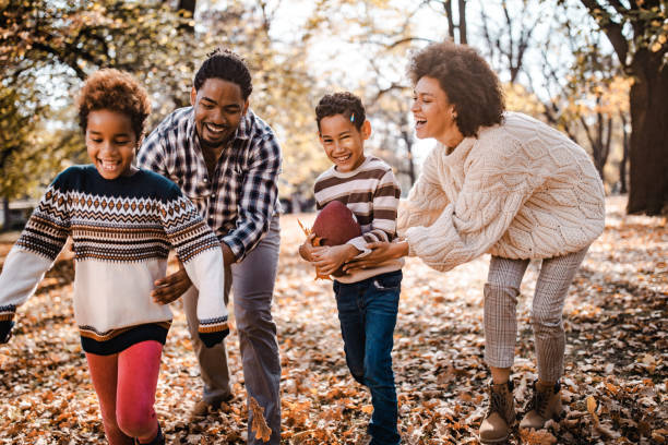 istock Playful black family having fun while playing rugby in the park. 1140942020