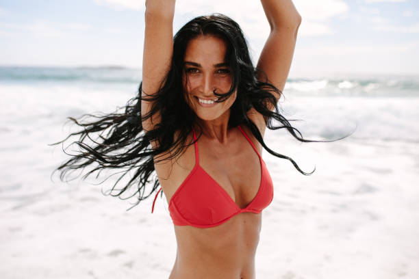 istock Joyous woman enjoying on the beach 1140942391