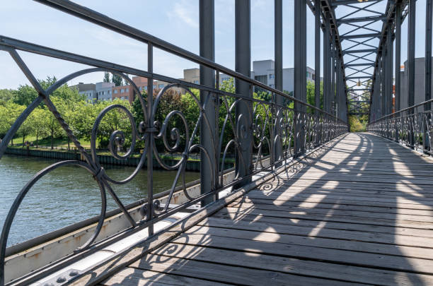 istock Footbridge Over River In City Against Sky 1140942994