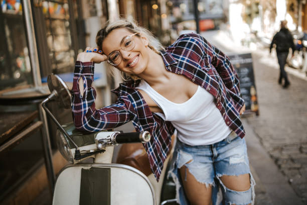 istock Beautiful woman leaning on her scooter 1140946022