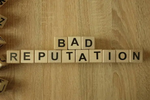 Photo of Bad reputation text from wooden blocks