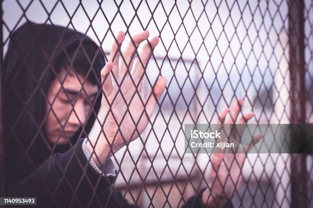 Sadness Man Stock Photo - Download Image Now - Chinese Ethnicity, Prison, Cage
