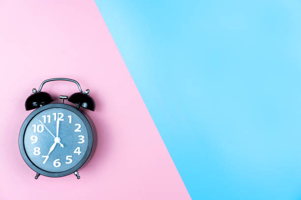 istock Alarm clock on color background. 1140954750