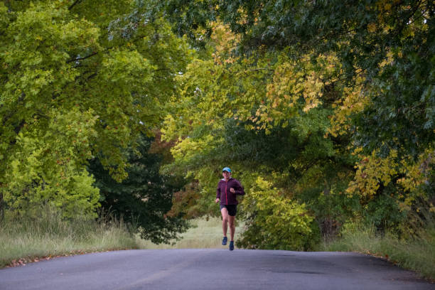 istock Woman running along the road 1140956611