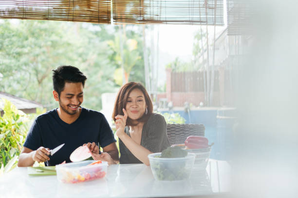 istock Young Lovely Couple Preparing Meal Together 1140958508