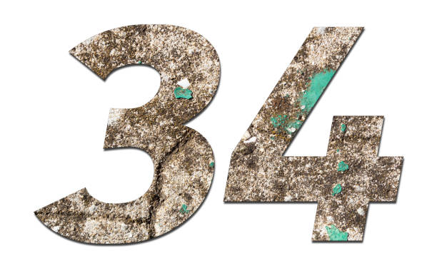 istock Number 34 with old wall on white background,Stone Number 1140960300