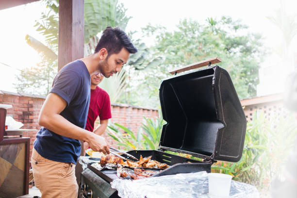 istock Young Man Preparing Barbecue Outdoors 1140961371