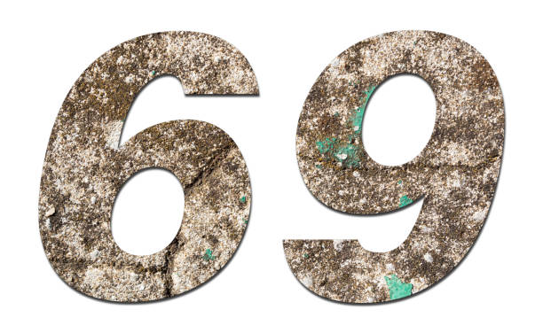 istock Number 69 with old wall on white background,Stone Number 1140961406
