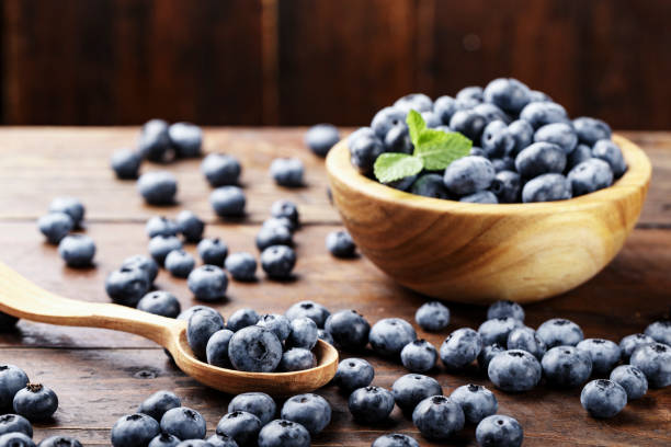 istock Fresh blueberries in a plate on a wooden table. 1140962692
