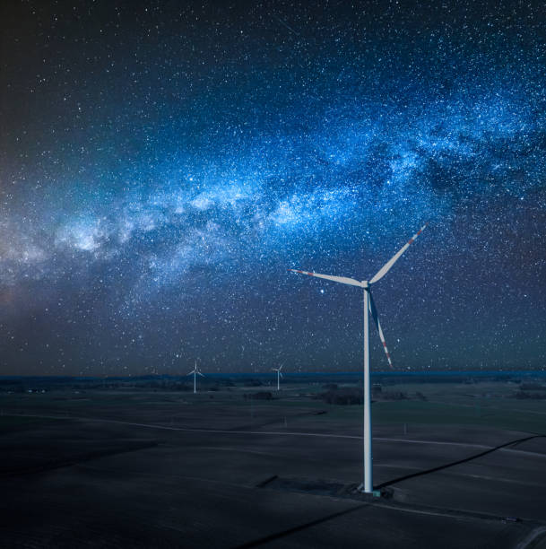 istock Milky way over wind turbines as alternative energy at night 1140964183
