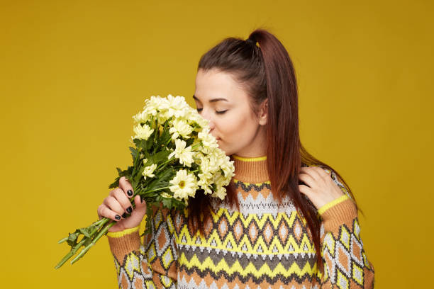 istock Young Caucasian female posing indoors on yellow studio wall. 1140964325
