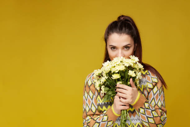 istock Young Caucasian female posing indoors on yellow studio wall. 1140964427