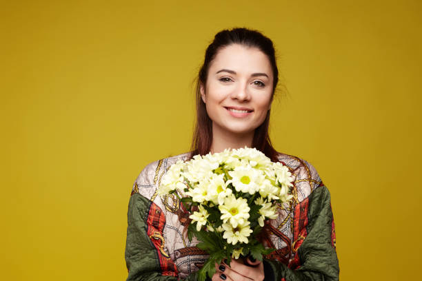 istock Young Caucasian female posing indoors on yellow studio wall. 1140964772