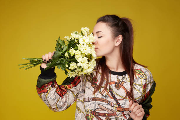 istock Young Caucasian female posing indoors on yellow studio wall. 1140964852