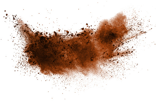 Explosion of deep brown powder on white background.