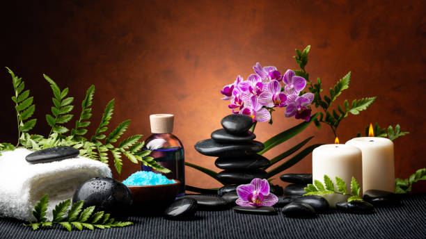 istock Spa, still life in the shadows with stones, orchids and essences 1140967473