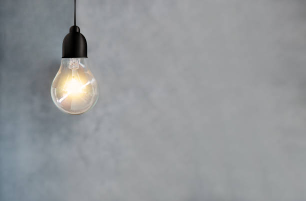 istock idea energy and light bulb on cement wall background 1140967490
