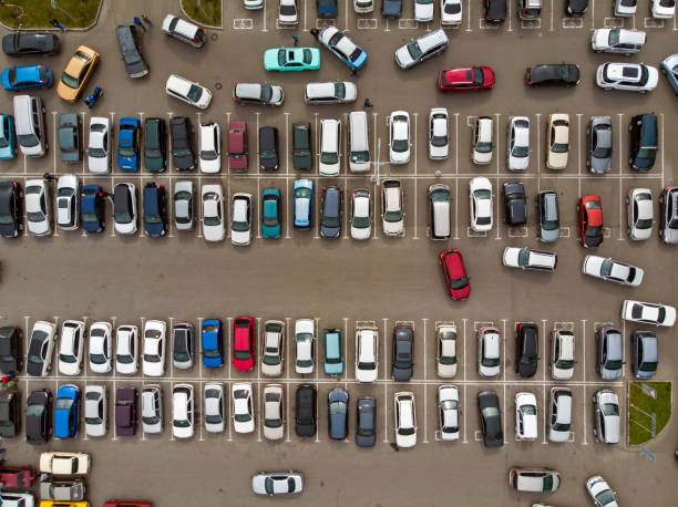 a view from above to the lines of parked cars. heavy traffic in the parking lot. searching for spaces in the busy car park. cruising for parking in dormitory area. difficulties of parking in the city - mannered imagens e fotografias de stock