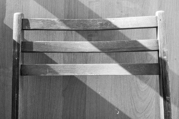 Still life black and white photo of a living room rocking chair furniture. Hand-woven all natural material.