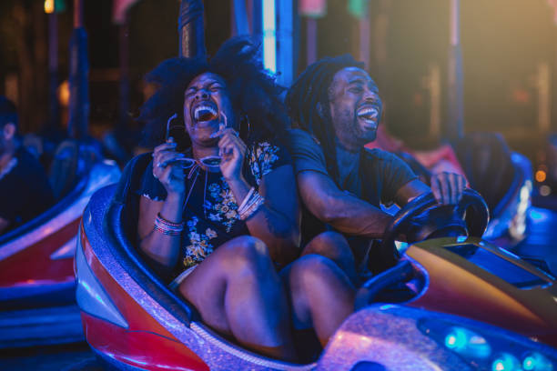 Love to ride with you Couple having good time at summer festival, they enjoy in bumper car ride. They ware casual clothing amusement park ride photos stock pictures, royalty-free photos & images