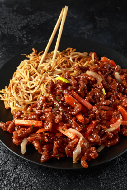 egg noodles with bean sprouts and Crispy shredded beef on black plate egg noodles with bean sprouts and Crispy shredded beef on black plate. beef pad stock pictures, royalty-free photos & images