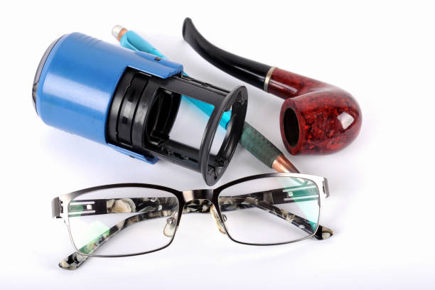 istock glasses, pen, smoking pipe on a white background. 1140972153