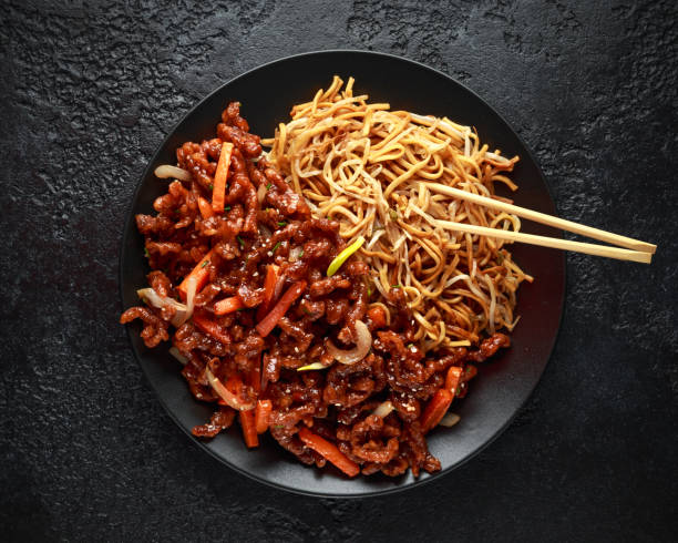 egg noodles with bean sprouts and Crispy shredded beef on black plate egg noodles with bean sprouts and Crispy shredded beef on black plate. beef pad stock pictures, royalty-free photos & images