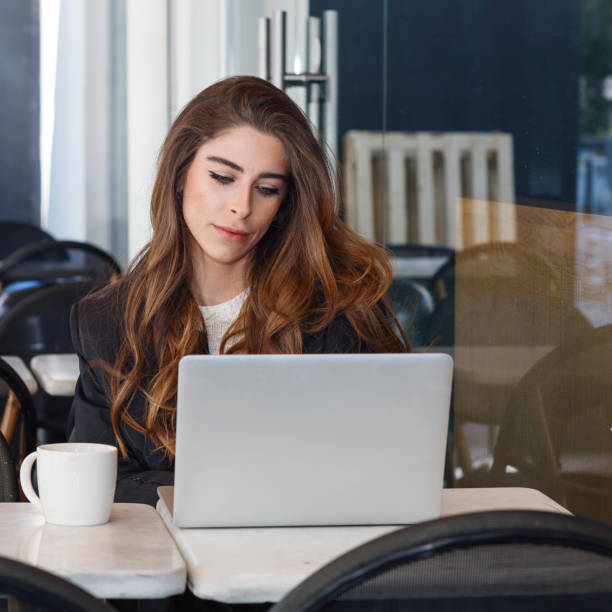 istock Successful businesswoman working at cafe 1140973632