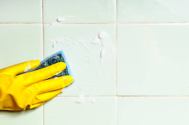 istock A human hand cleaning washing tiled surface in bathroom 1140974647
